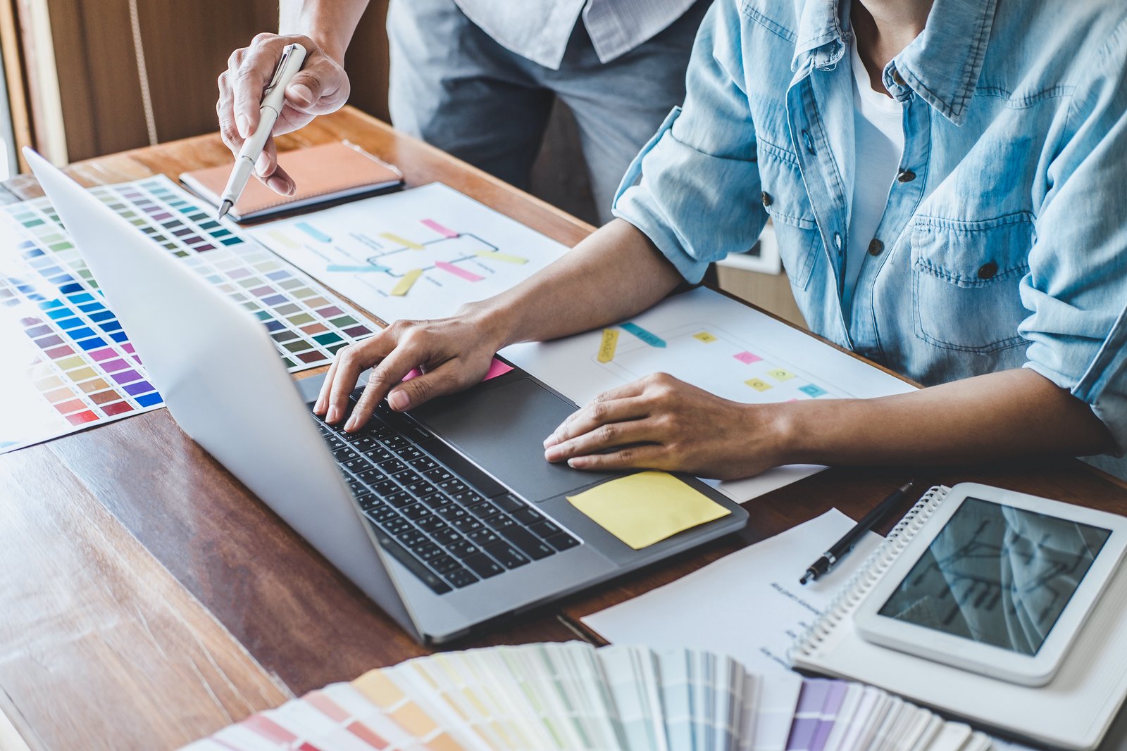 Designers reviewing an AI-assisted design workflow at a desk